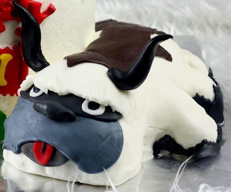 Strawberry cake on top of white cake with Avatar airbender Appa