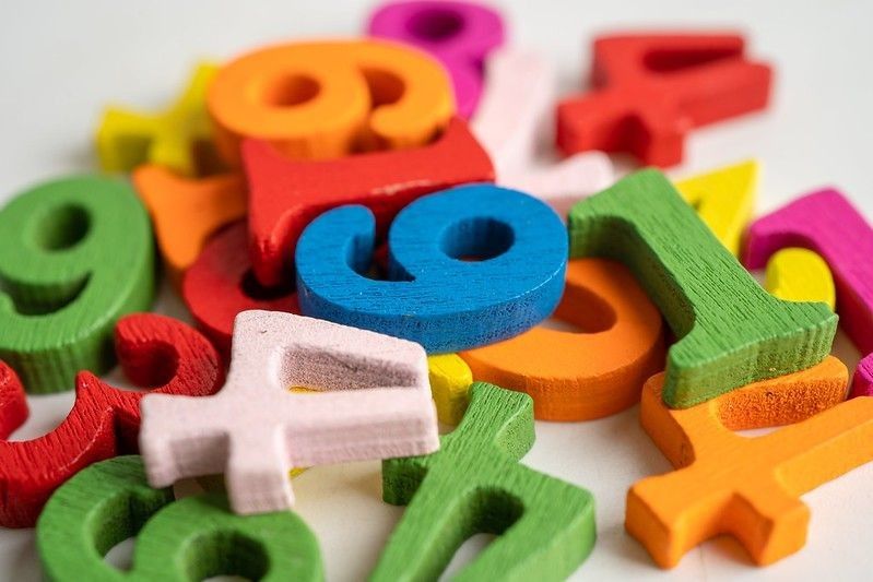 Colorful numbers scattered on white background