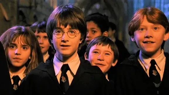 Harry, Ron and Hermione in the Great Hall