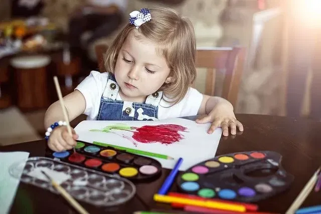 Young girl painting doing arts and crafts