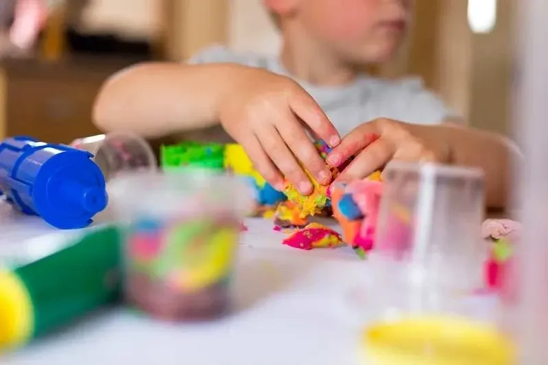 A child doing some creative playdough arts and crafts at home. Image