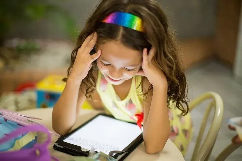 Young girl playing an online word game.