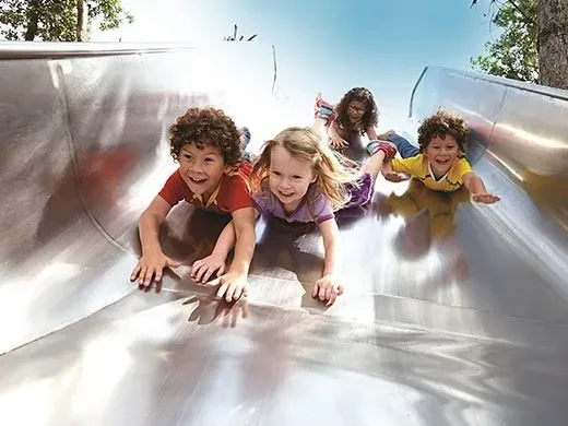 kids sliding down the slide at queen elizabeth olympic park