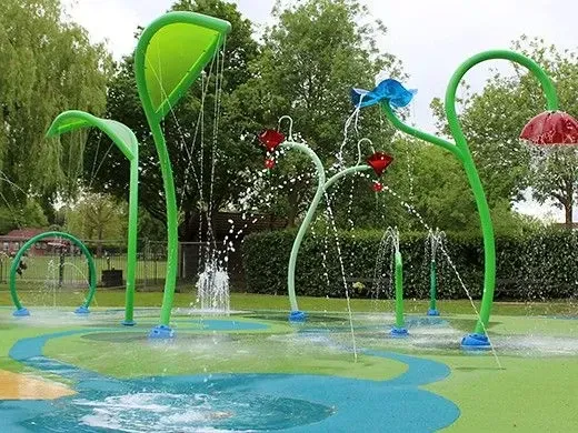 splash pad in park with tropical sprinklers and colourful water jets