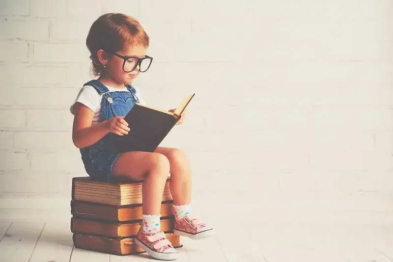 A young child starts learning to read.