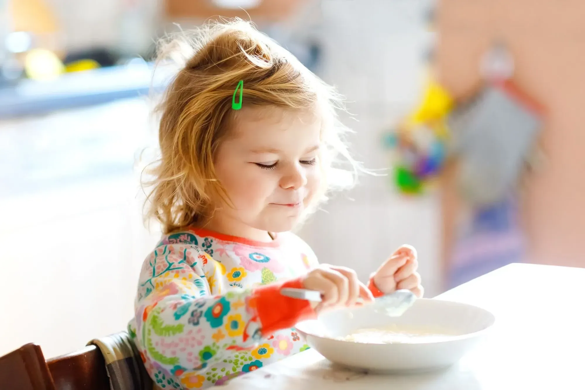 Young child enjoying her breakfast.