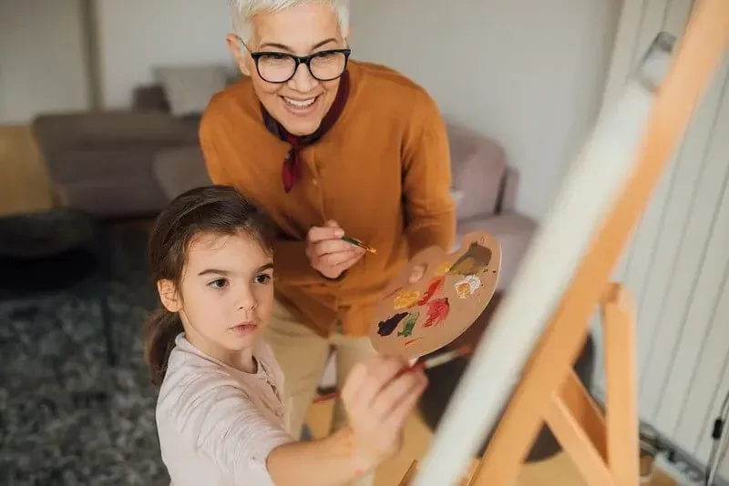 Grandmother helping child make famous art copy for kids project