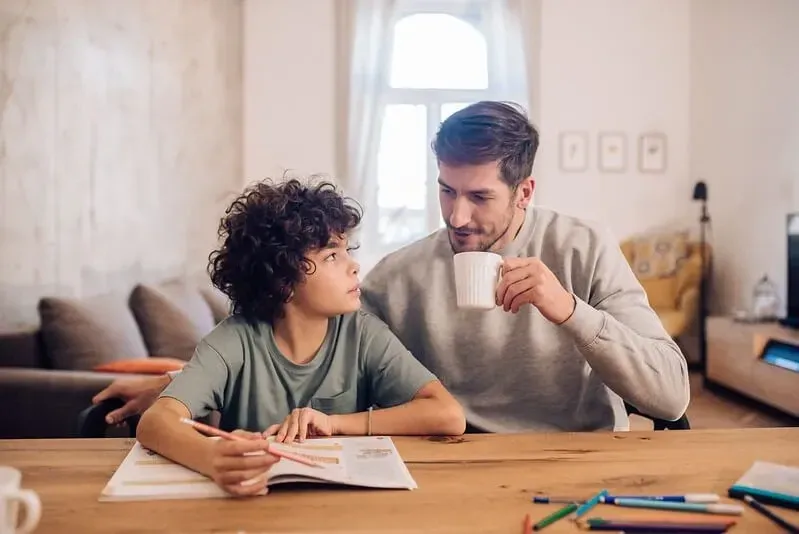 Father teaching his son how to practice long division