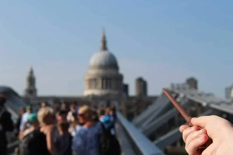 hand pointing a wand towards st paul's cathedral