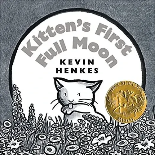 Front cover of Kitten's First Full Moon. There is a white cat in the centre of a white moon, licking its paw. The background is plain grey, and in the foreground at the bottom are outlines of grey flowers.