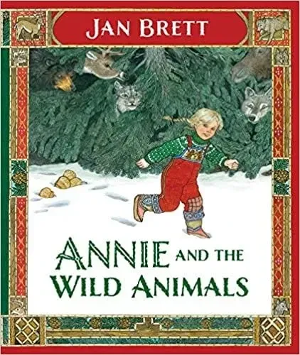 Cover of Annie And The Wild Animals: a young girl is smiling as she moves in the snow. In the background are some trees, with some animals hiding among them.