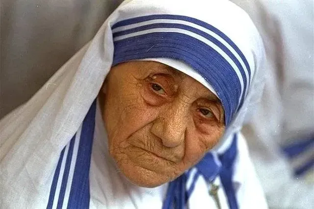 Mother Teresa wearing her iconic blue and white headscarf.