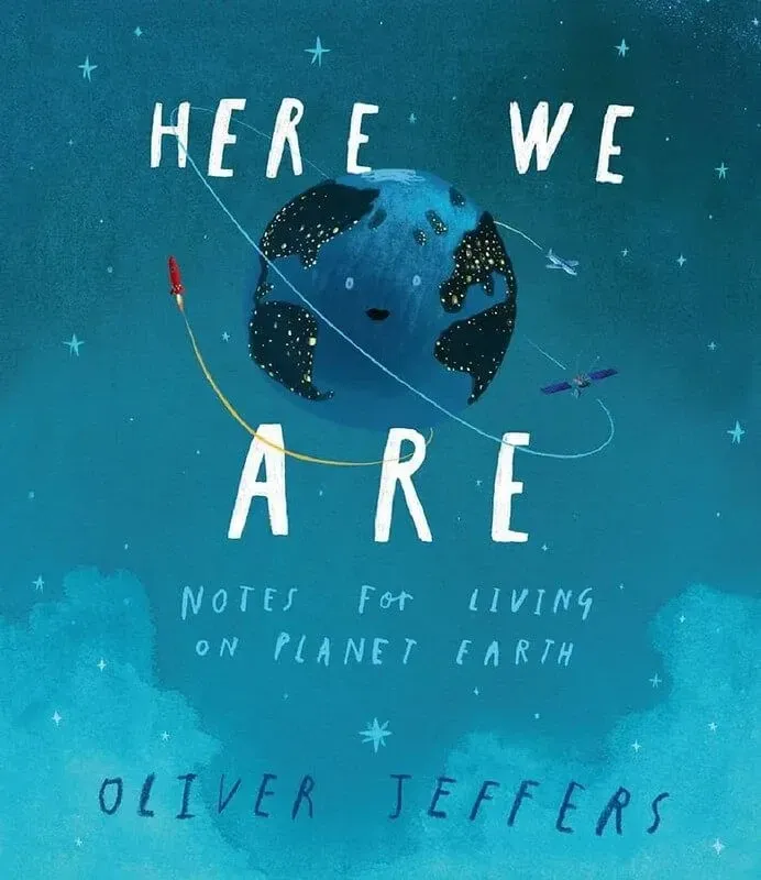 Here we are notes for living on planet earth by Olliver Jeffers blue book with smiling blue earth in the centre