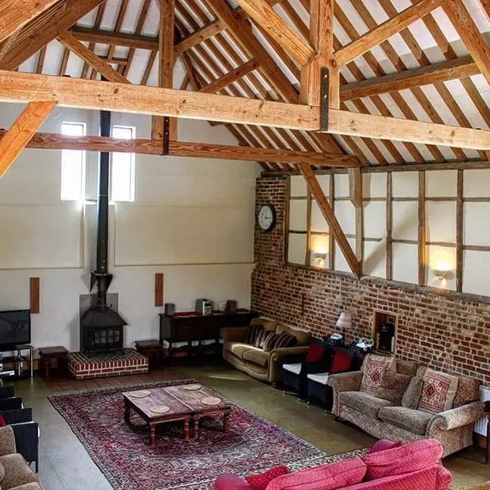 Beautiful living room with fireplace in a cottage at Burgate Manor Farm.