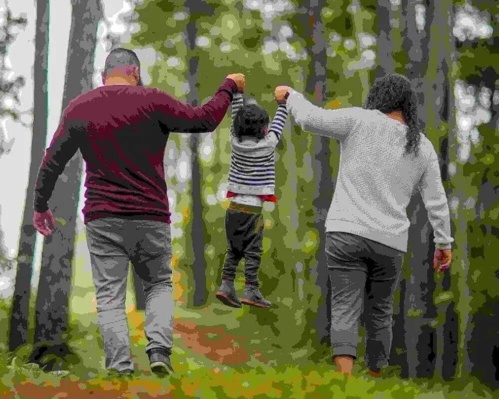 Family walking in open green forest outside of London.
