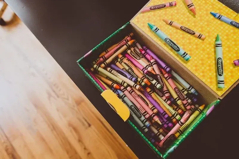 Open box of colouring crayons for fairytale crafts.