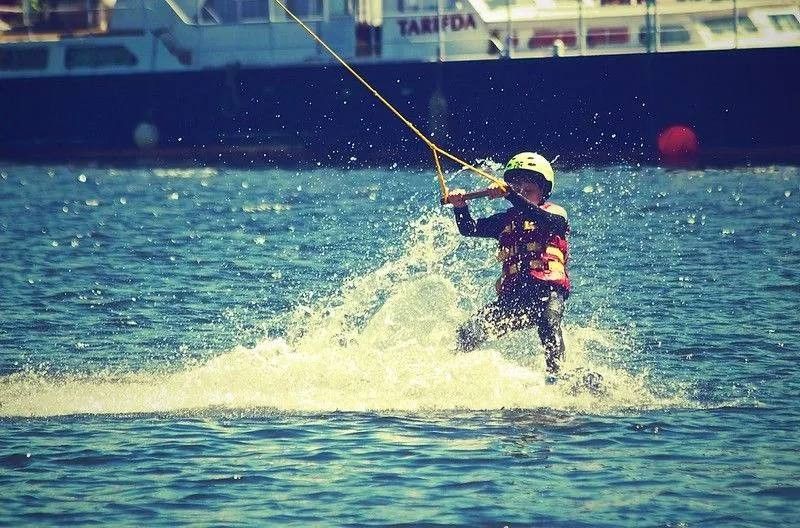 Young boy on waterski with helmet and lifejacket