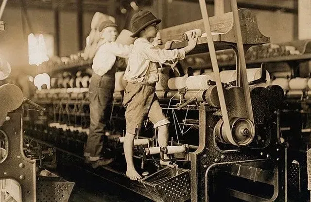 Two young boys working in the weaving factory.