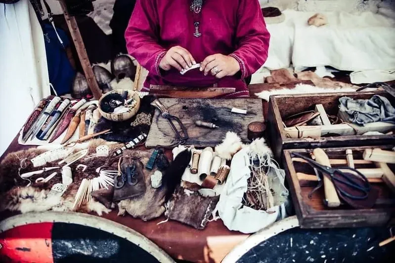 Woman behind a stall selling Viking accessories. 