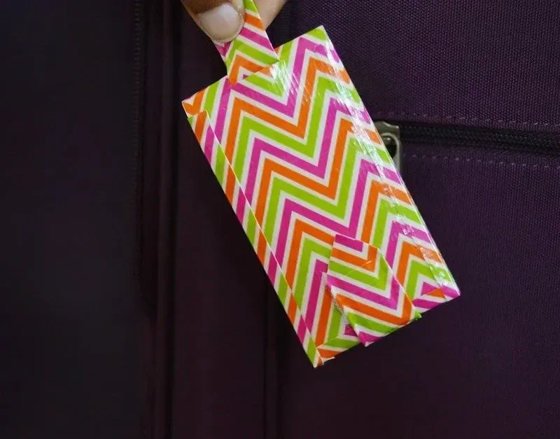 DIY luggage tag made from colourful, zig-zag tape.