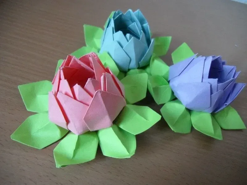 Three origami lotus flowers and leaves.