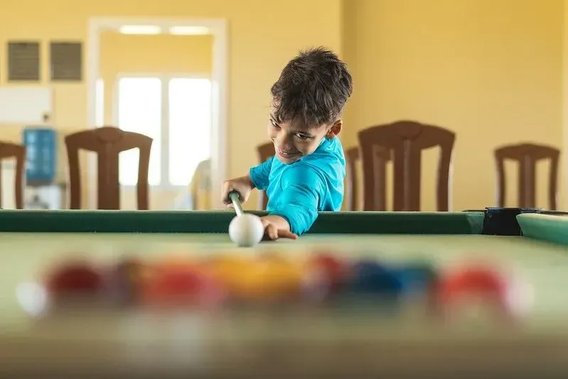 Boy playing pool