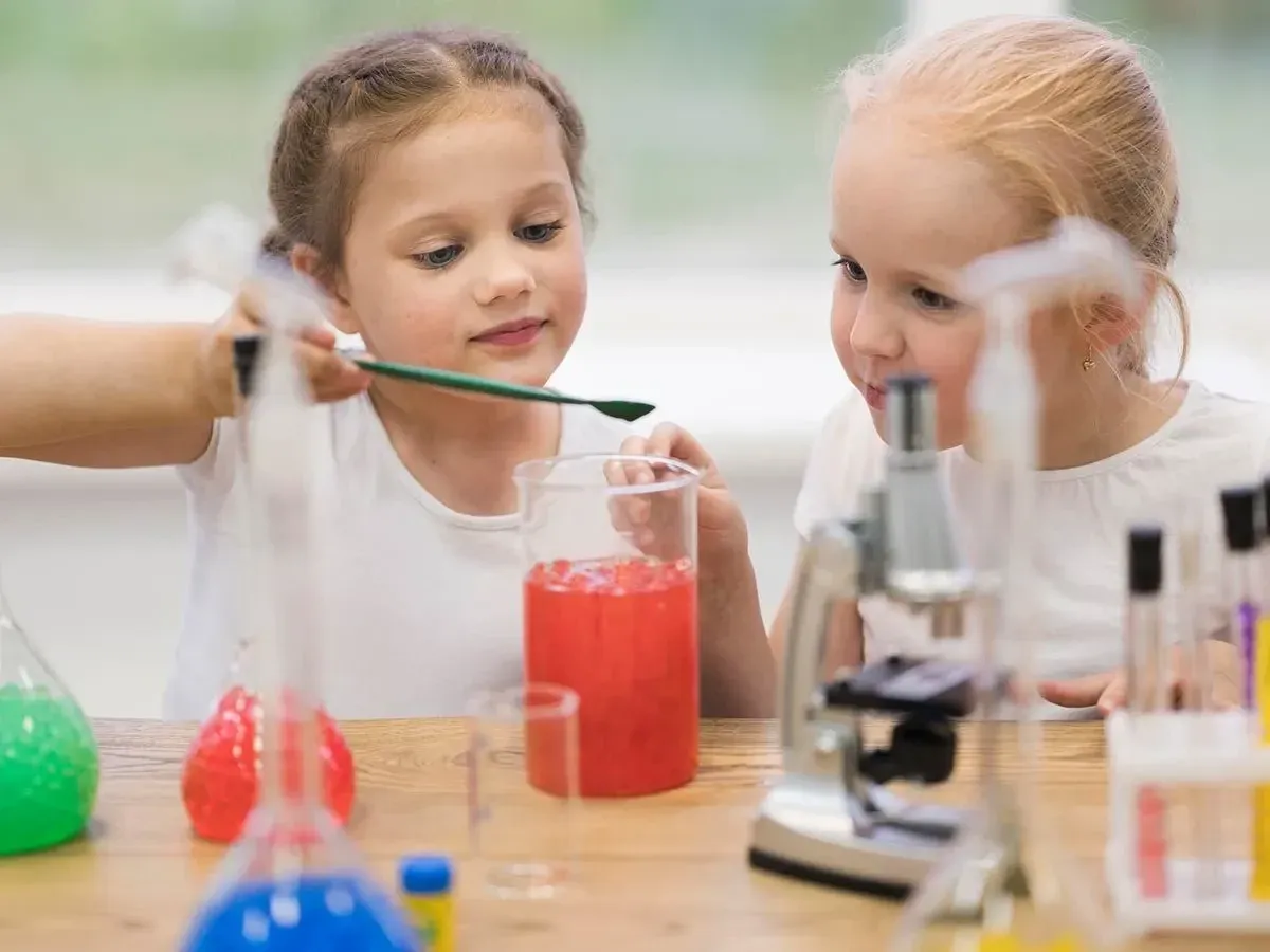 Two preschooler girls doing science experiments.