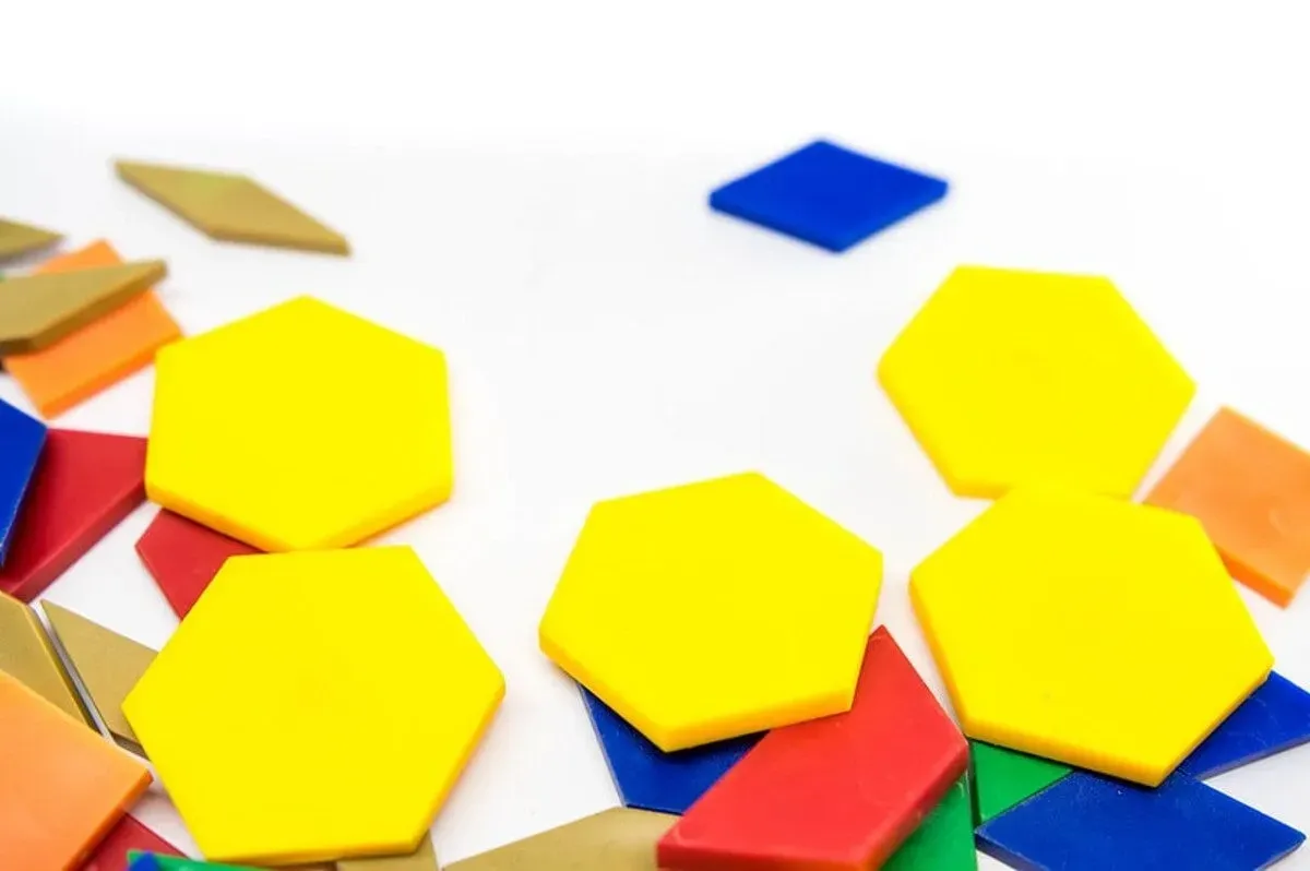Colourful plastic geometric shapes used to explain symmetry to KS2 kids.