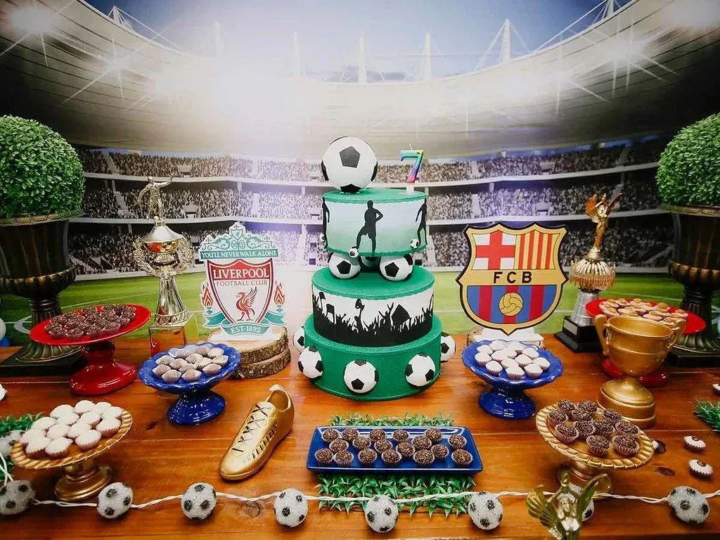 A display of cakes and snacks at a sports themed birthday party.