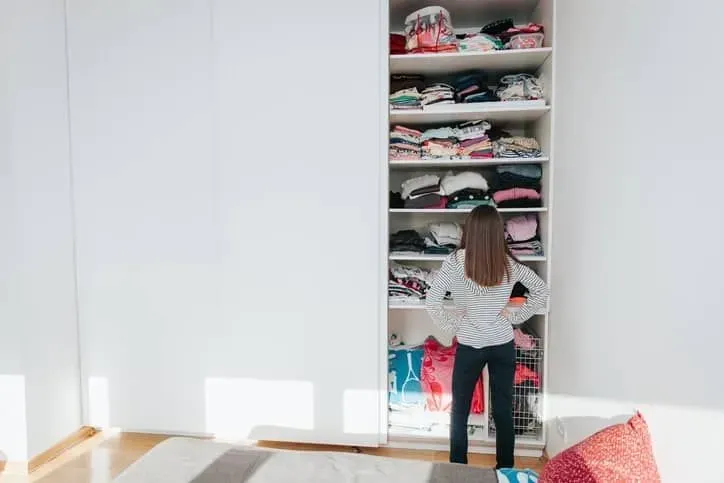 Girl standing in front of wardrobe. 