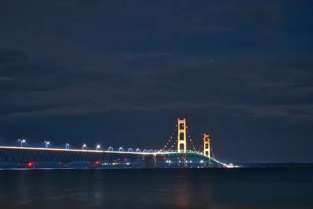 The Mackinac Bridge is lit up at night.