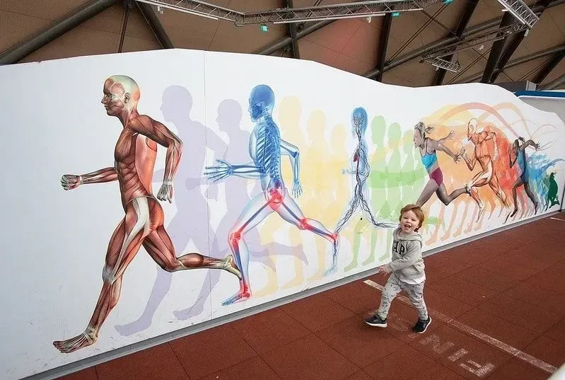 A young child running alongside an interactive gallery at the Glasgow Science Centre.