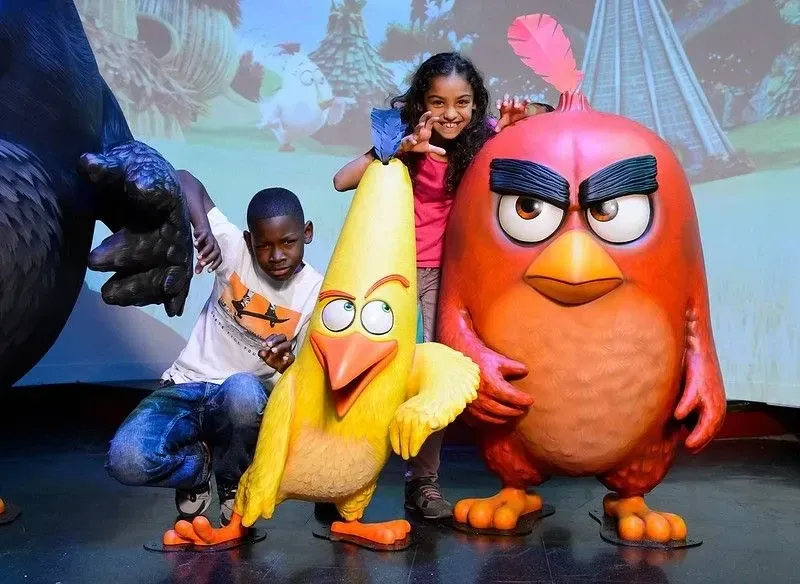 Boy and girl posing with two Angry Birds characters at Madame Tussuds.