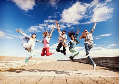Happy group of friends jumping.