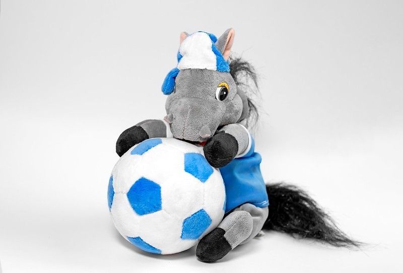 A donkey toy with a ball isolated on a white background