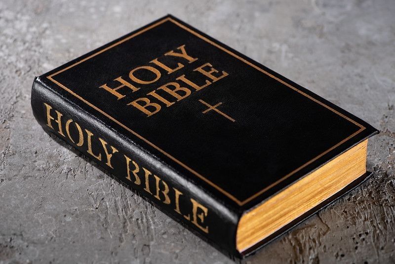 Holy Bible on a gray surface.