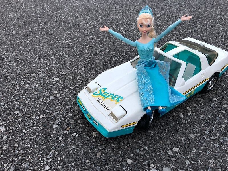 Elsa from Frozen riding in a white Barbie Super Corvette
