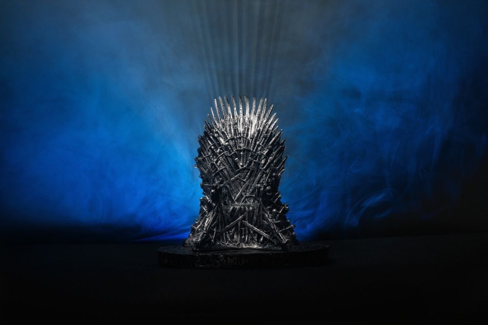 The model of throne as in Game of throne at a bright blue smoked background
