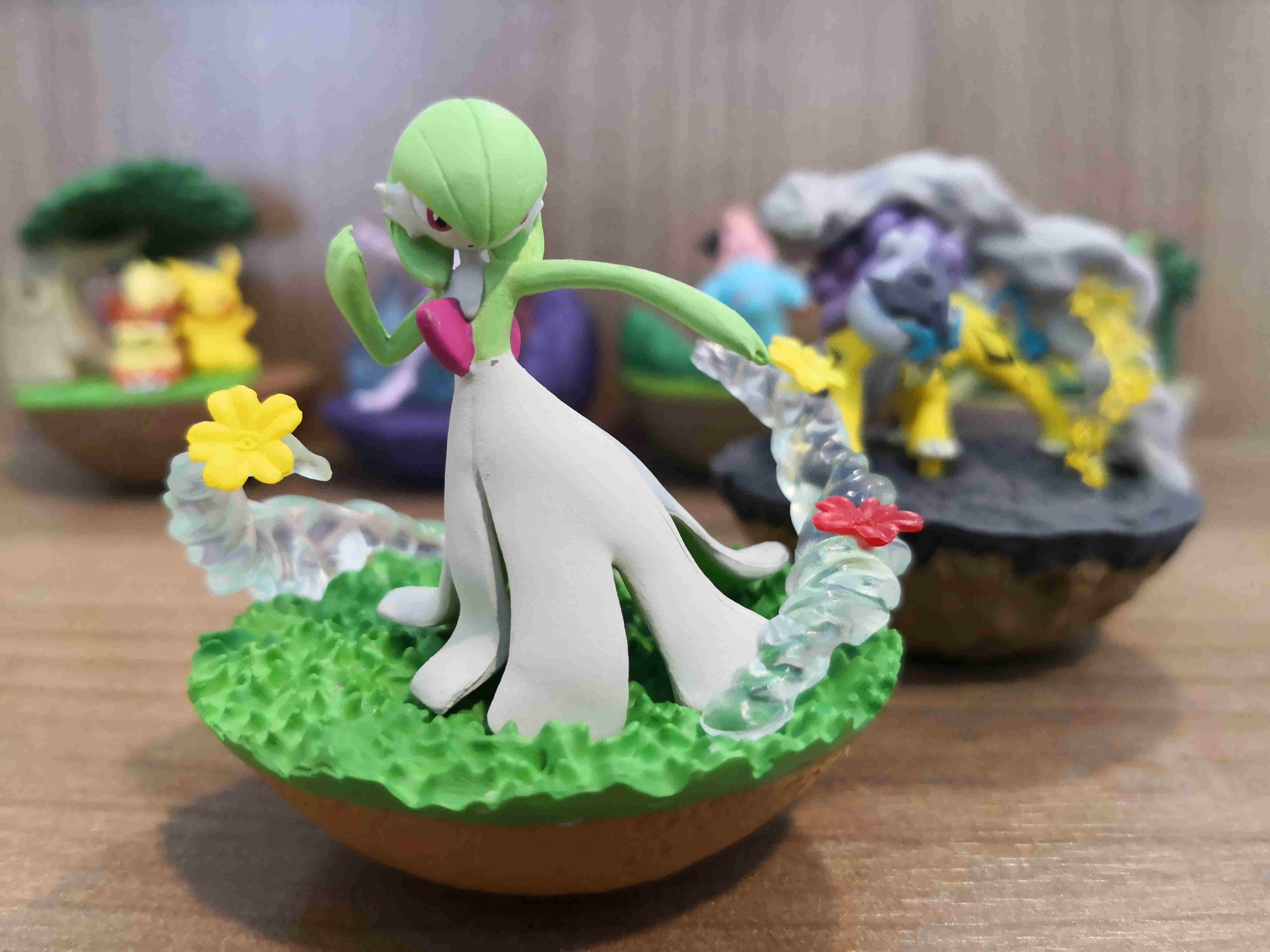 A Statue of Gardevoir Pokemon on a Green Land.