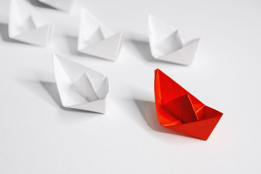 Business and Leadership. Unique Paper Boat Leading The Rest By Example.
