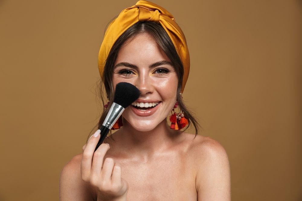 A young Woman holding makeup brush