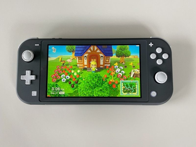 A Nintendo Switch Lite with the game Animal Crossing New Horizons running on it.