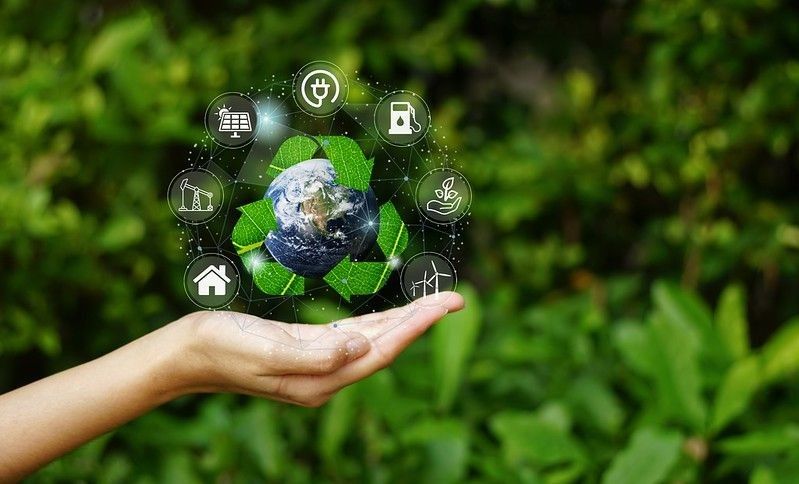 Hand holding Planet Earth with recycle symbol over the Network connection on nature background