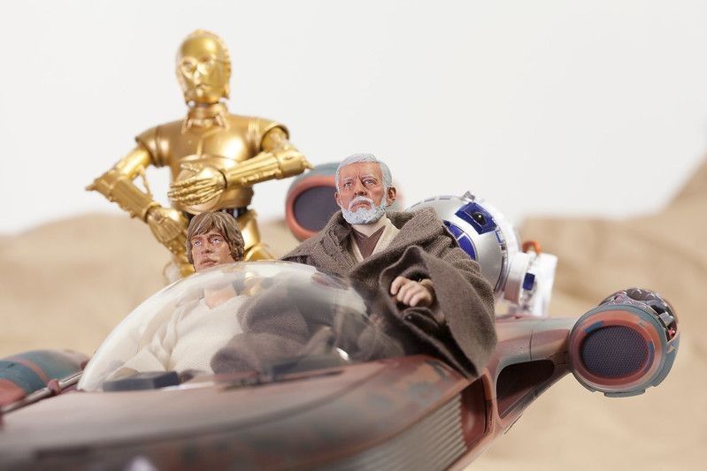 Obi Wan 'Ben' Kenobi and the droids R2D2 and C3P0 riding in a X34 Landspeeder