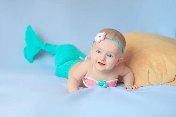 Baby girl dressed up in little mermaid costume