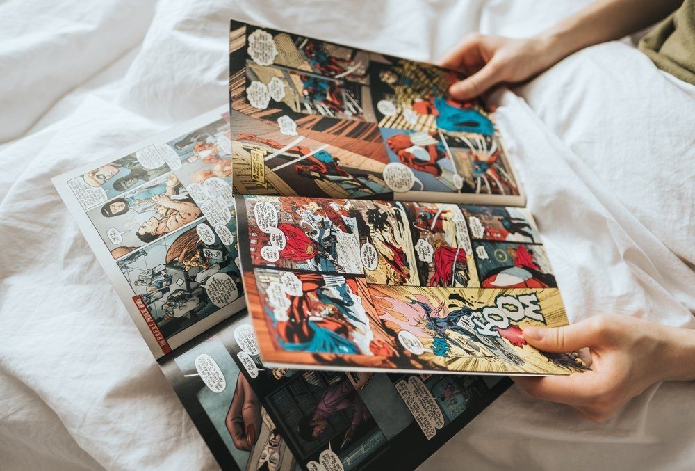 Women reading comics in bed at home
