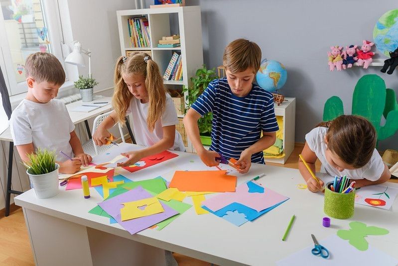 Kids making art with color papers