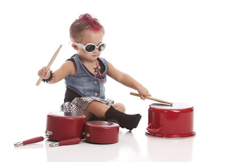 Adorable toddler with a pink mohawk and banging on pots and pans