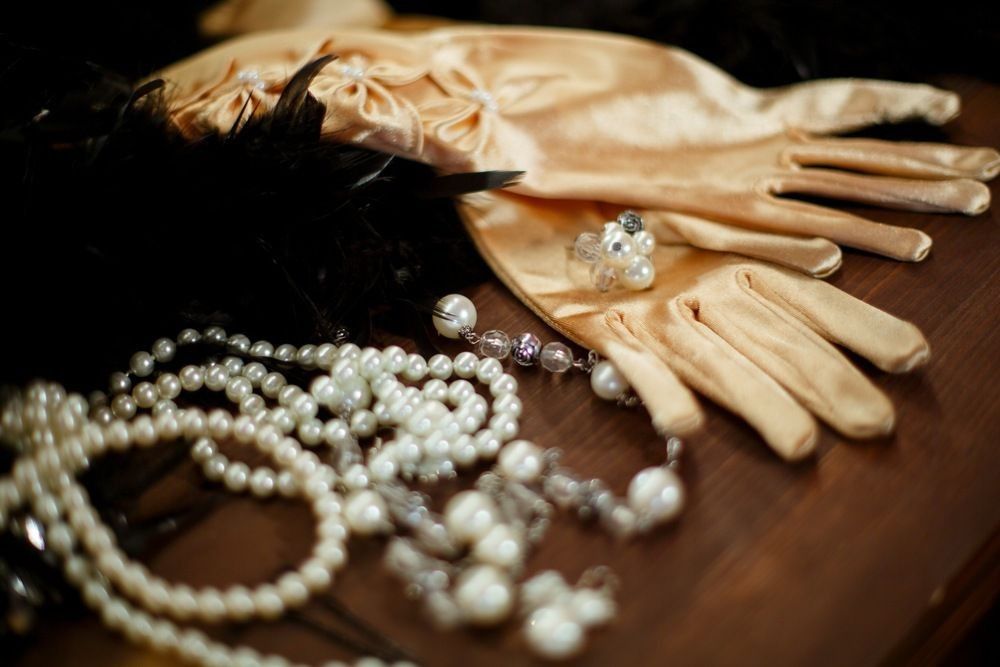 Beige satin gloves decorated with white beads, ring and beads.