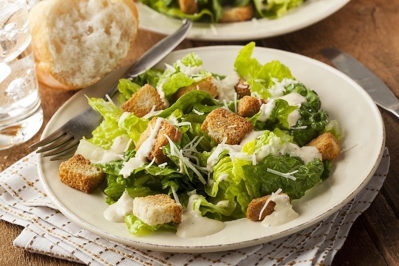 Healthy Green Organic Caesar Salad with Cheese and Croutons.